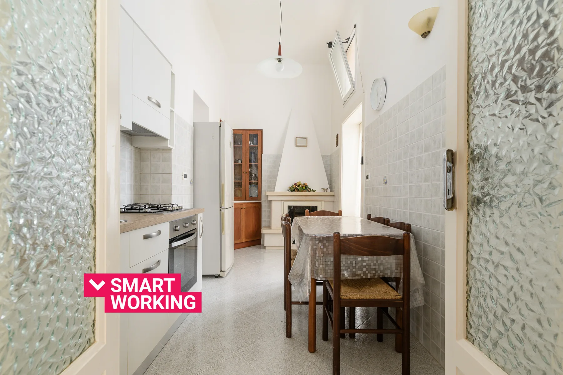 A bright kitchen and dining area with a table beside the cooking counter.