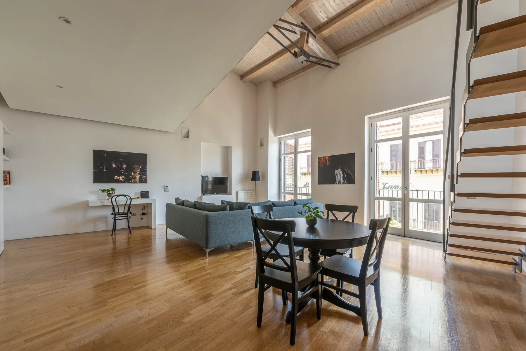 A bright open-plan living and dining room with a dining table and seating.