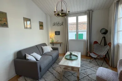 A bright living room with a gray sofa and a low coffee table.