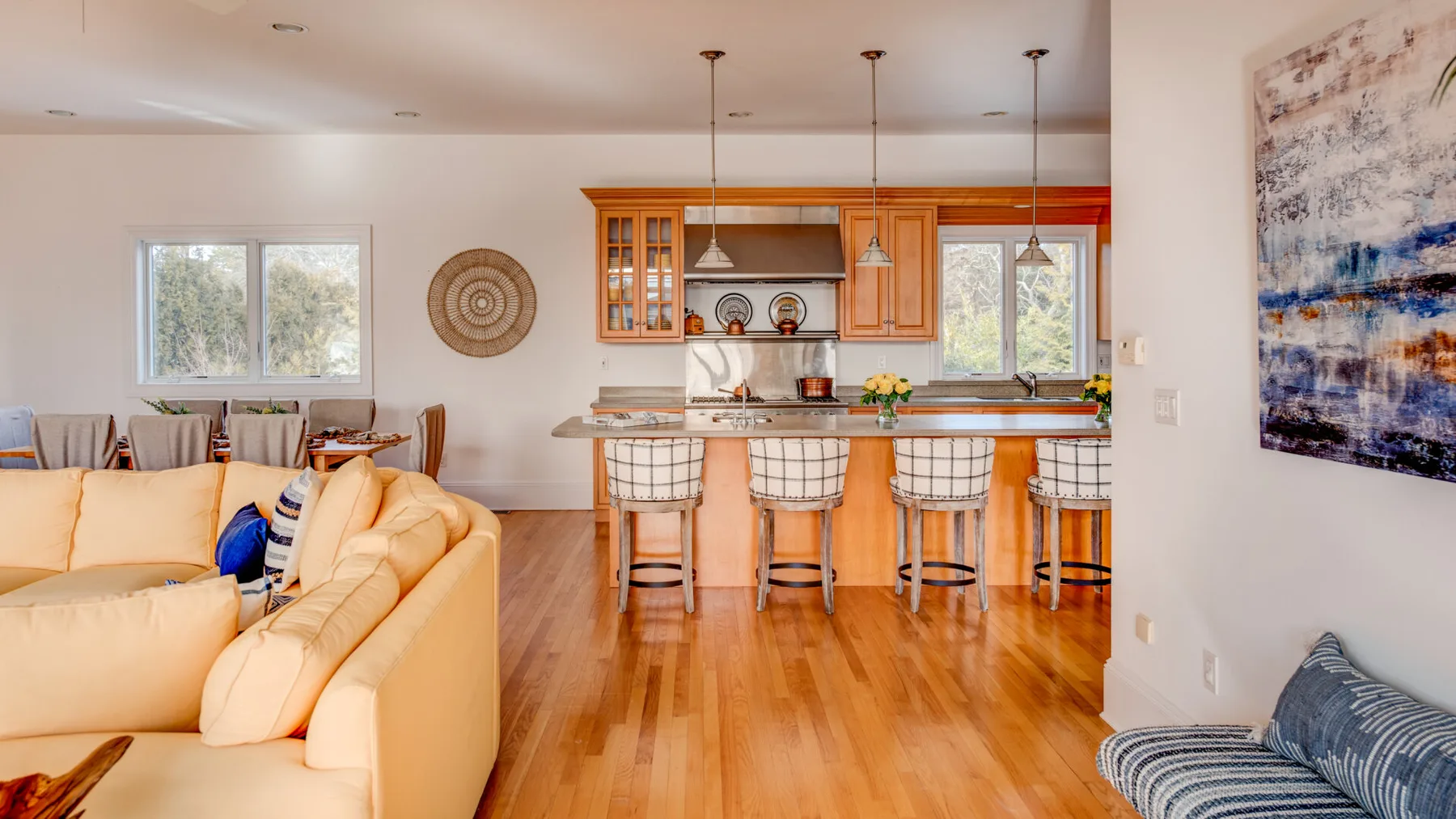 An open-plan living room and kitchen with a breakfast counter and seating.