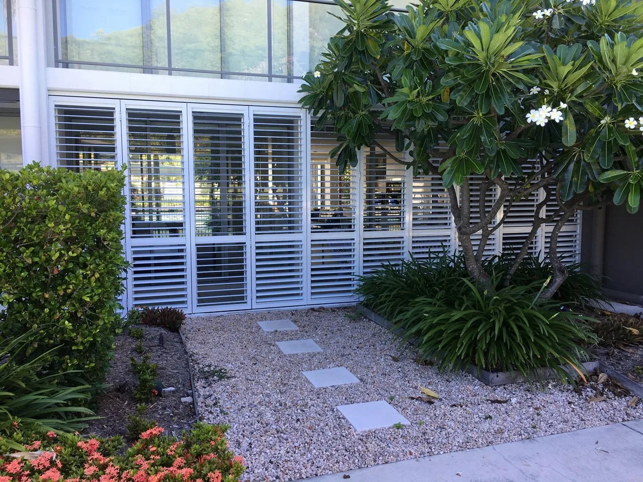 A landscaped courtyard with a gravel path and stepping stones.