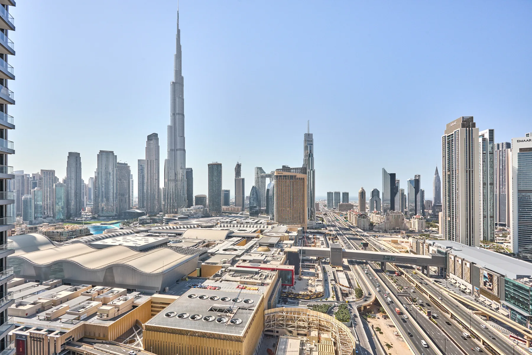 City skyline with tall skyscrapers and elevated roads in the foreground.