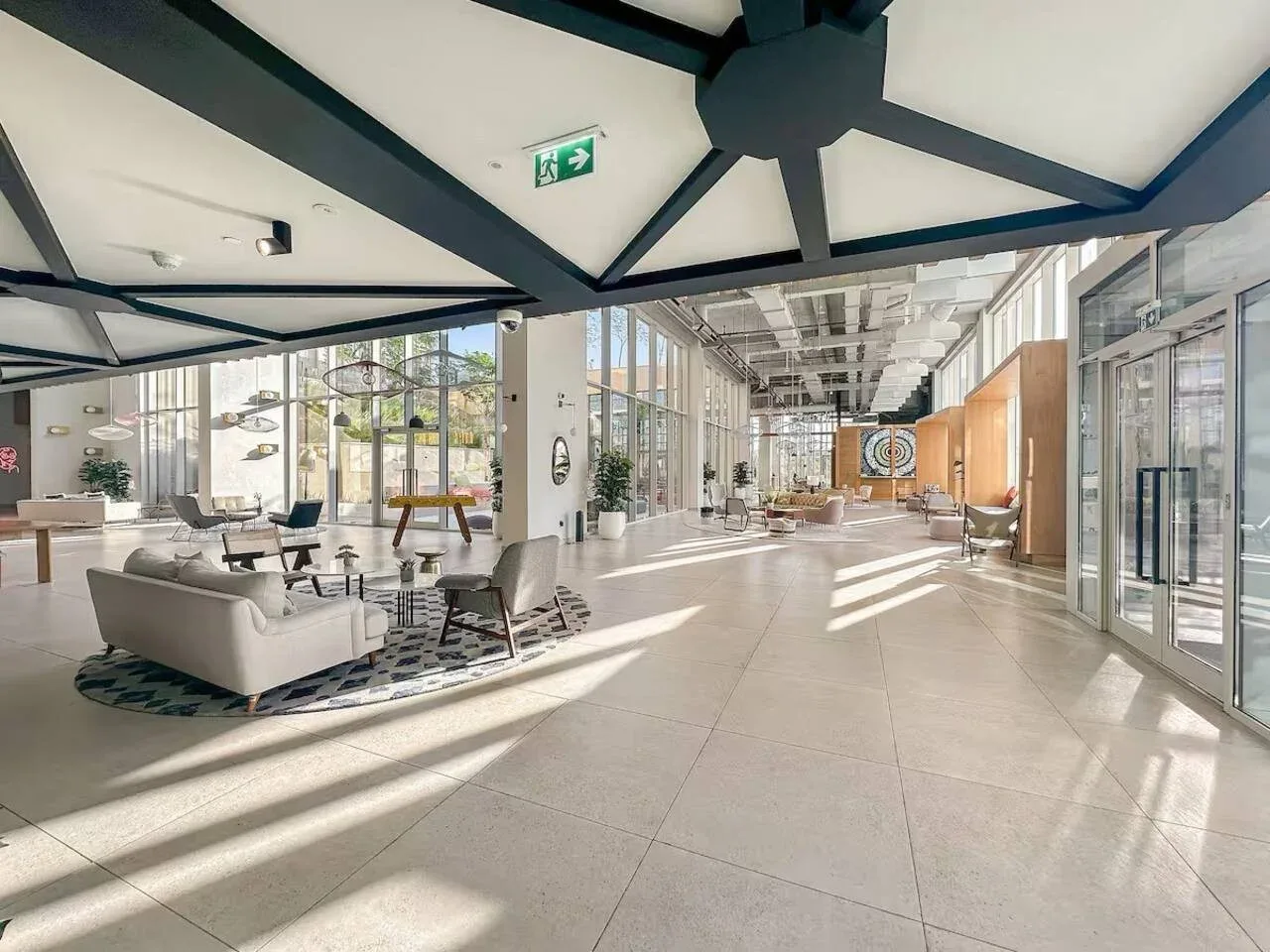 A bright, spacious lobby with a seating area and large glass windows.