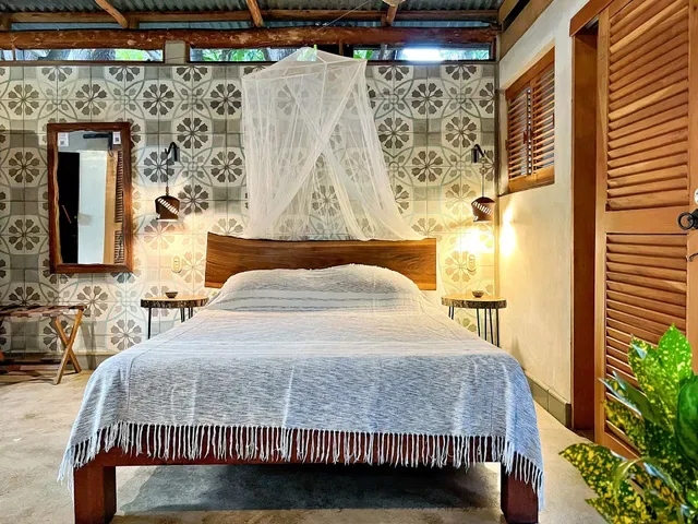 Bedroom with a bed and sliding door.
