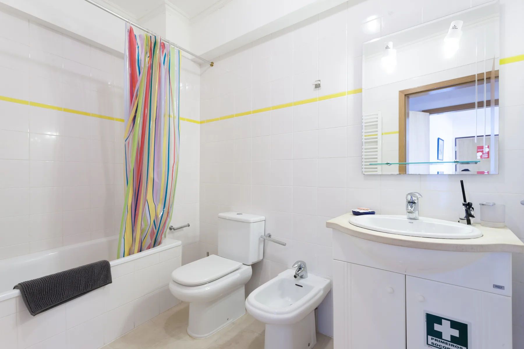 Un baño alicatado con bañera, inodoro, bidé y lavabo.
