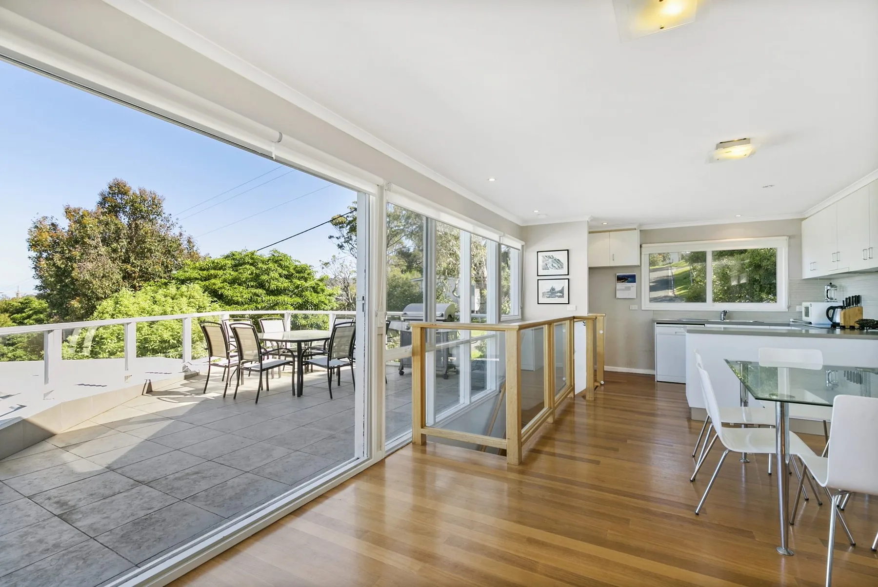 A bright kitchen and dining area opens onto a spacious outdoor terrace.