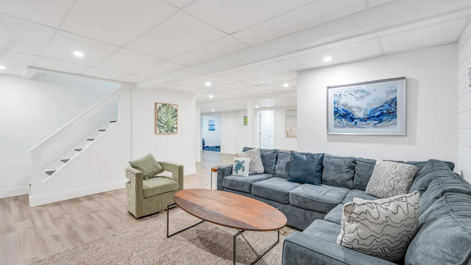 A bright living room with a large sectional sofa and a wooden coffee table.