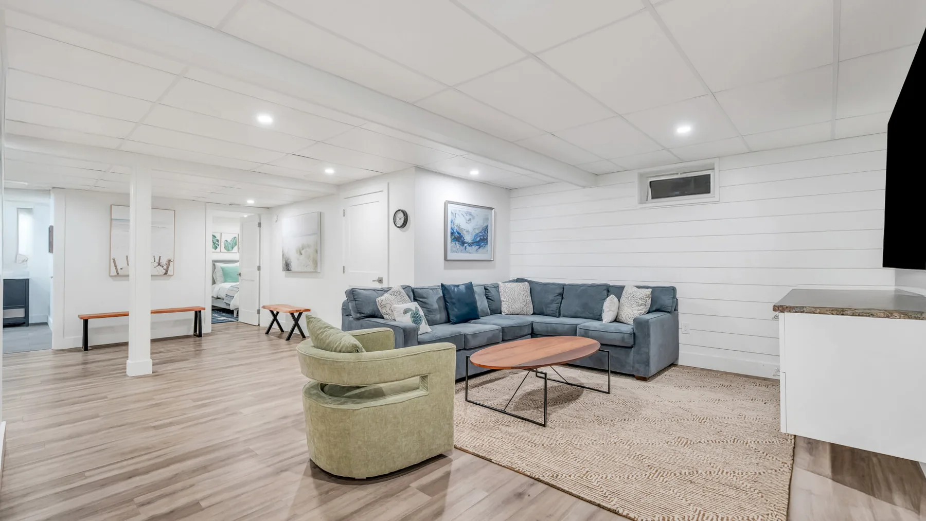 A bright living room with seating arranged around a coffee table.