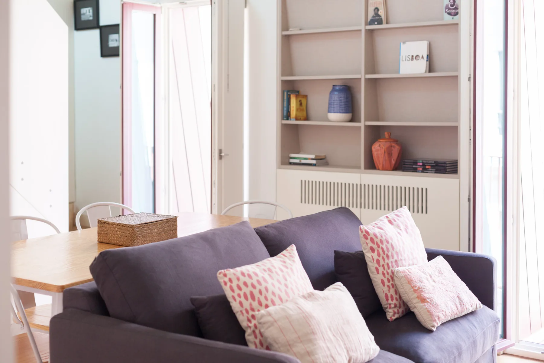 Living room with a seating area and built-in shelving.
