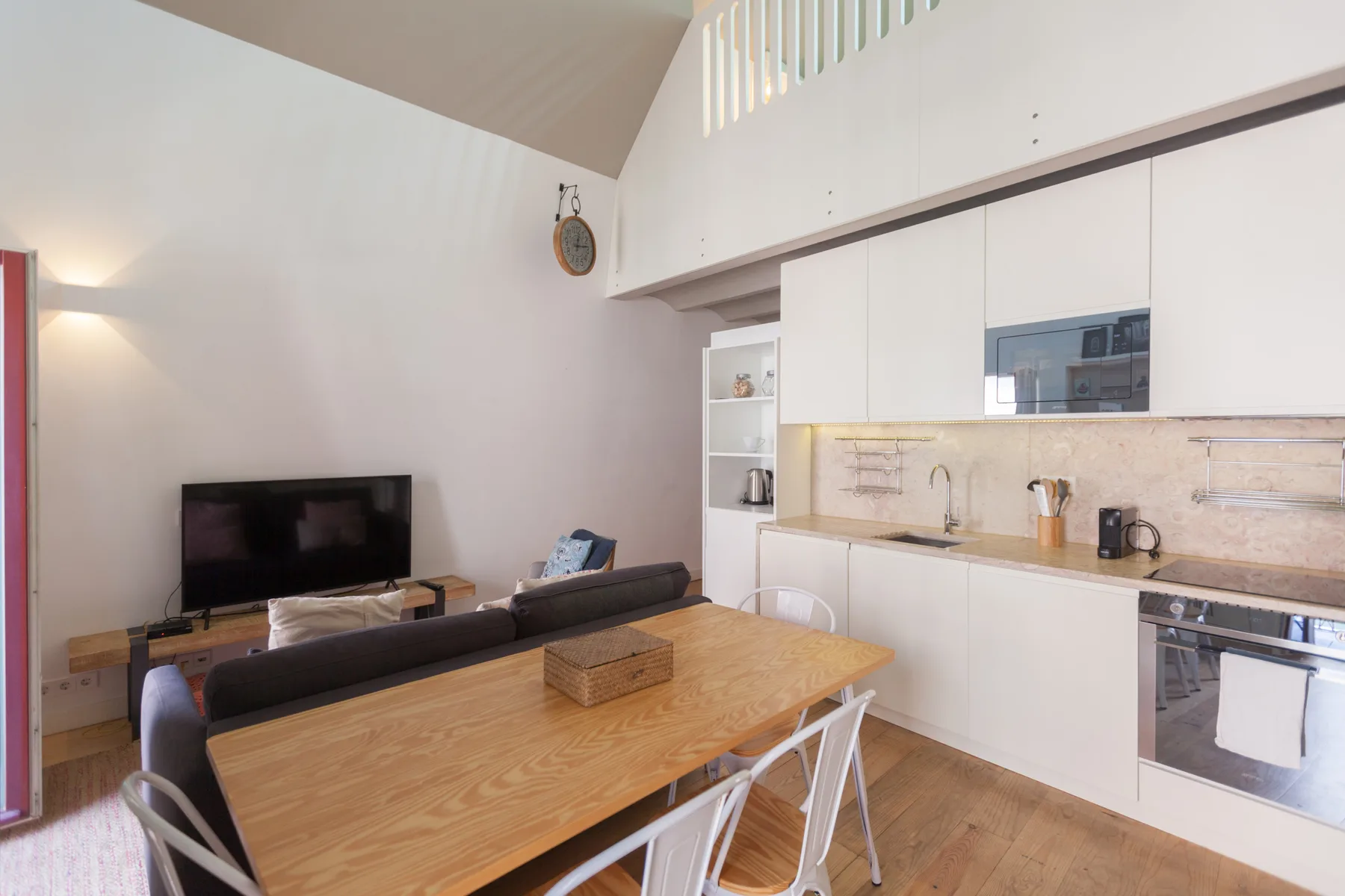 An open-plan living and dining area with a kitchen along the wall.