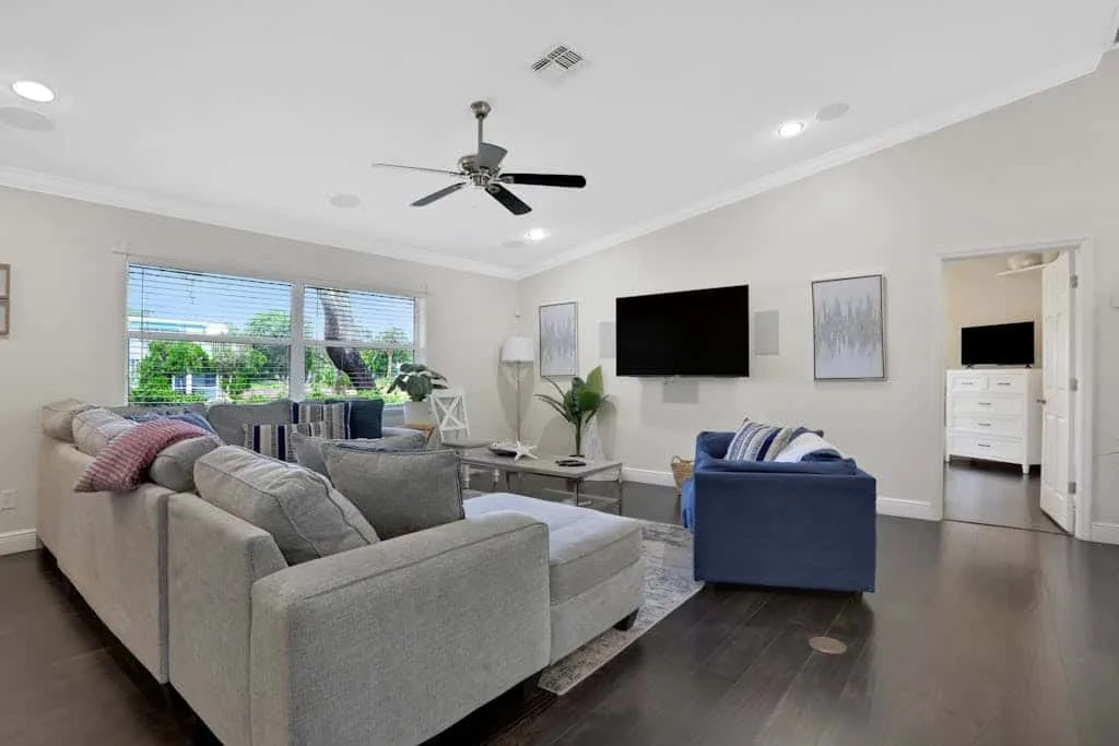 A living room with seating arranged around a television and coffee table.