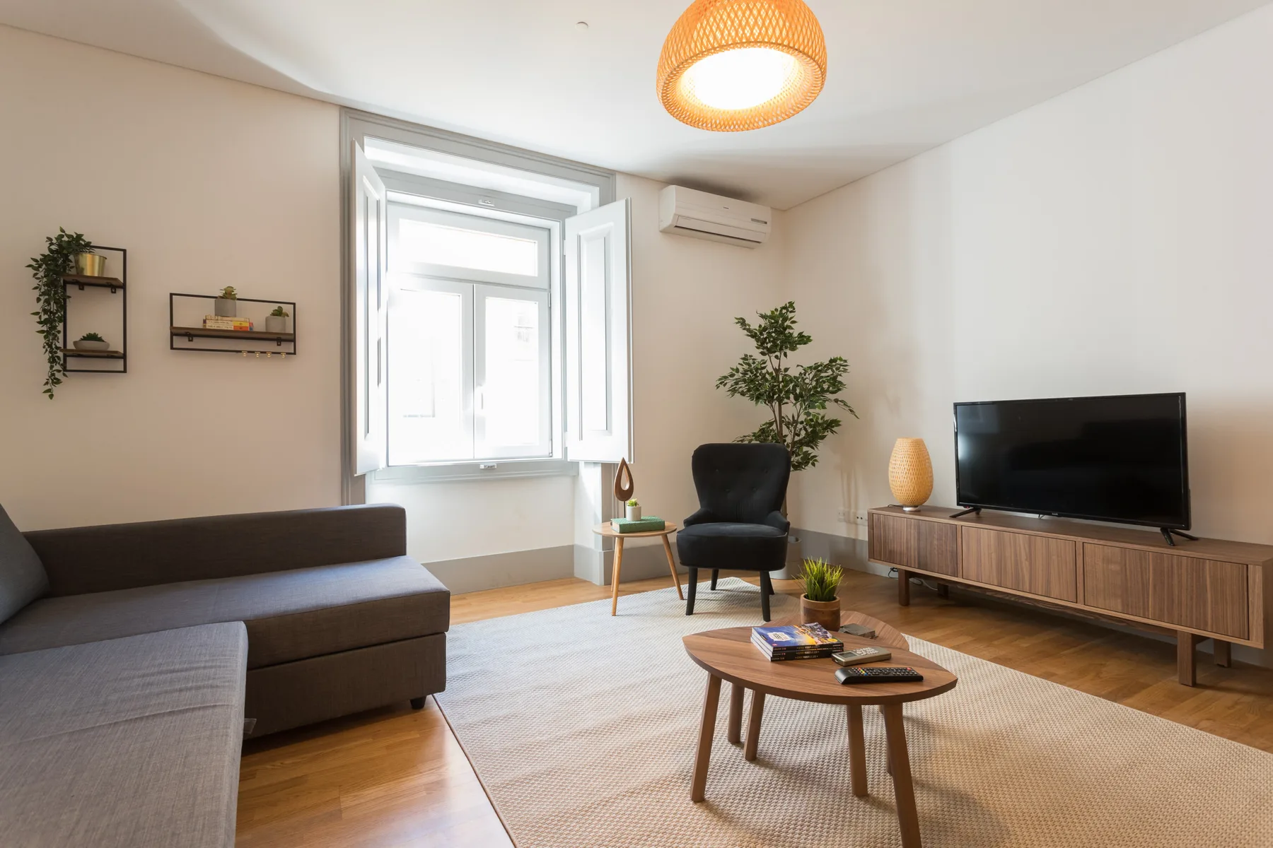 Sala de estar con asientos, un televisor y una mesa de centro.