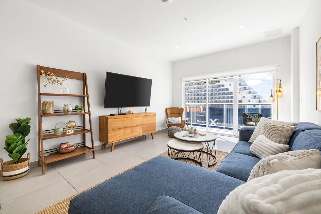 Sink into this stylish living room with modern amenities and calming coastal vibes. Natural light, plush seating, and entertainment await your arrival.