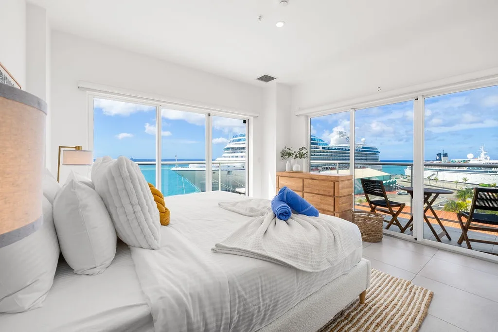 Imagine waking to stunning ocean views and cruise ships drifting by your window. Sink into the soft linens, step onto your private terrace, and let the tropical breeze embrace you.