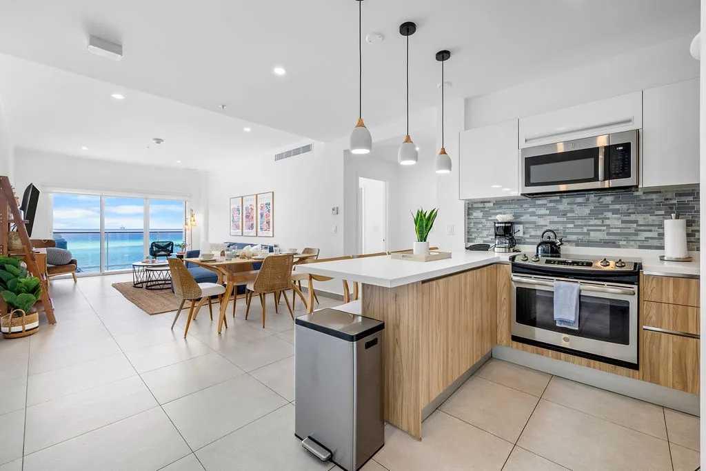 Wake up to sweeping ocean views from this bright, open-concept space. Sleek pendant lights and a fully-equipped kitchen invite you to cook and gather comfortably while soaking in the serene coastal scenery.