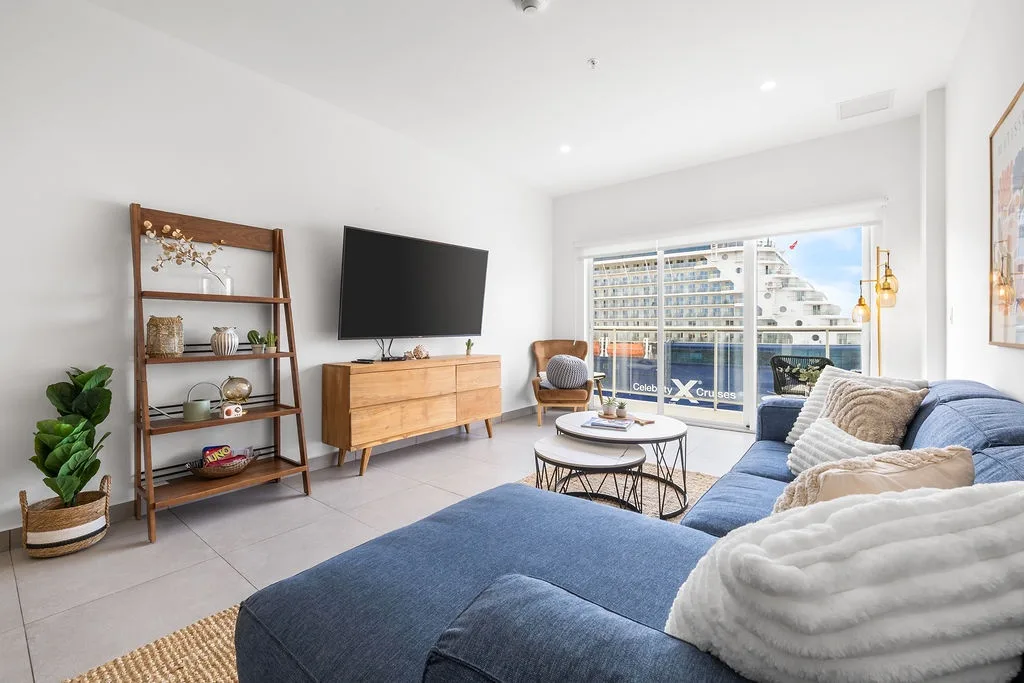 Sink into the plush blue sectional and feel instantly at home in your sunlit living space, complete with modern conveniences and stylish touches throughout.