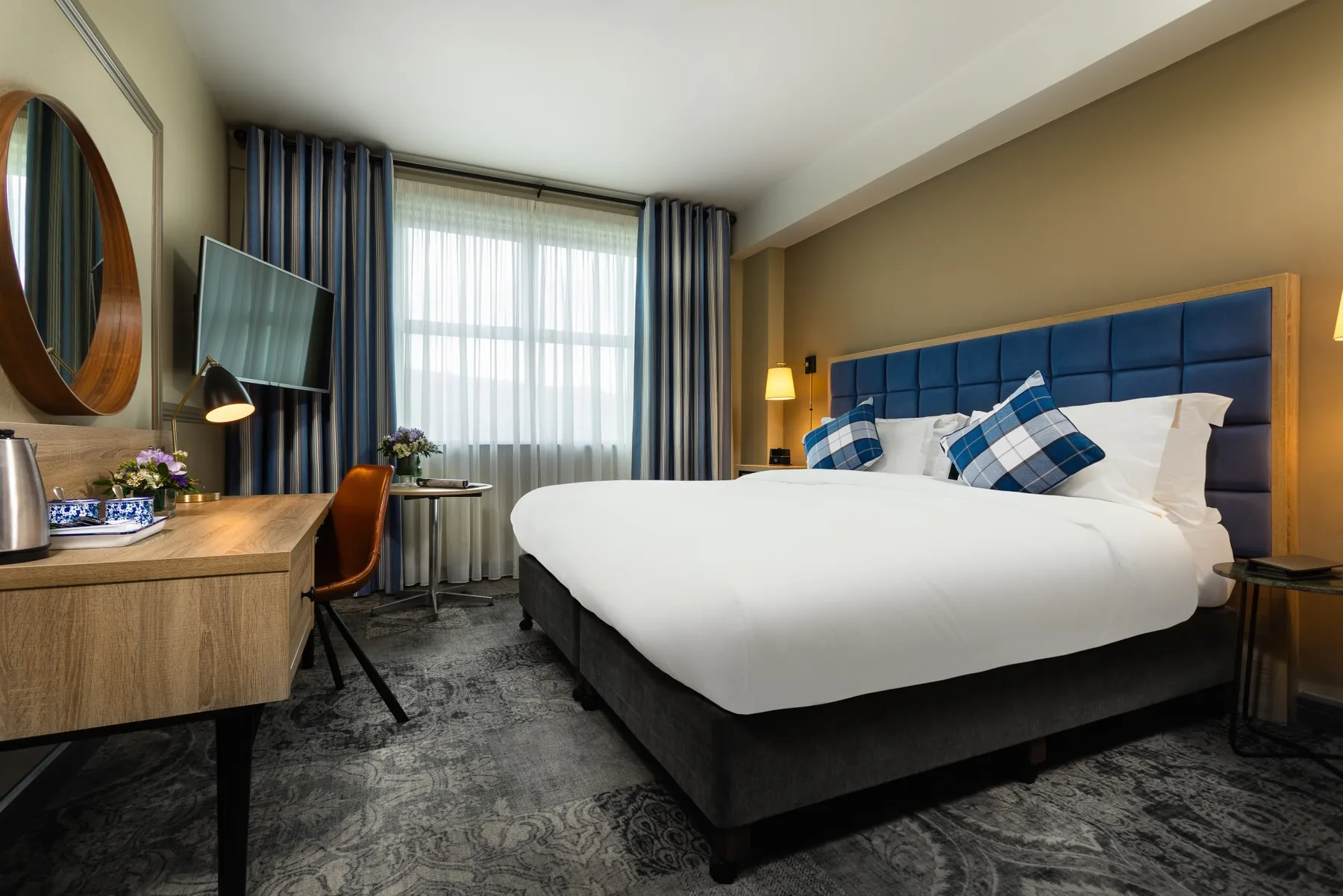 Bright modern interior of a Deluxe King Room.