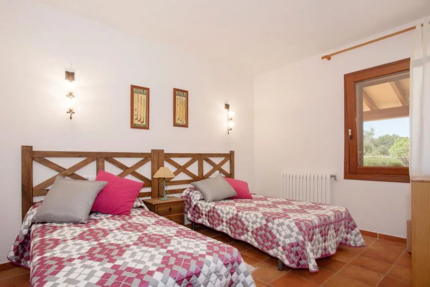 A bedroom with two beds dressed in patterned bedding.