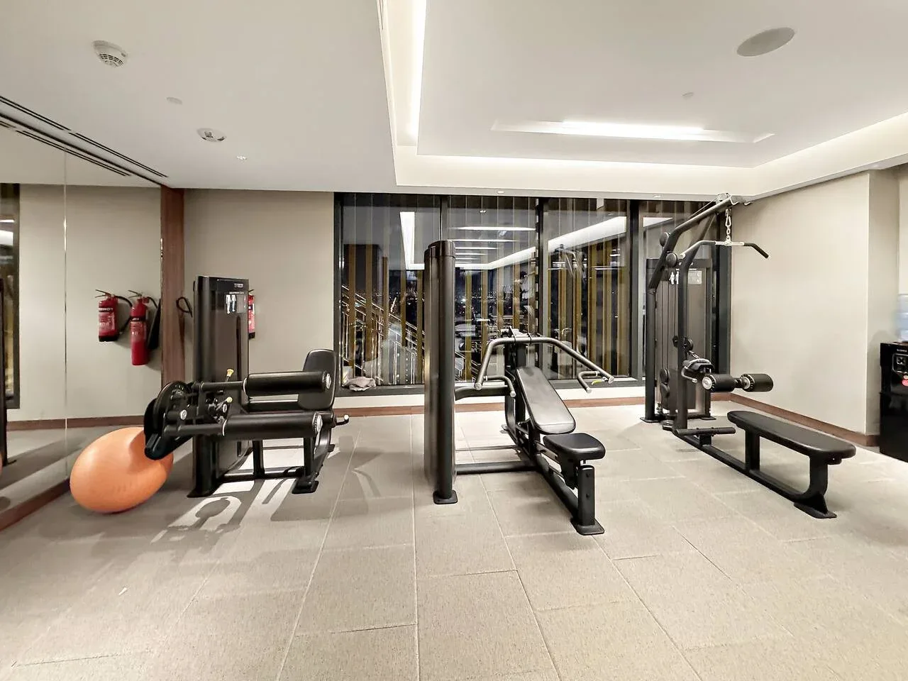 A gym with exercise machines and a weight bench.