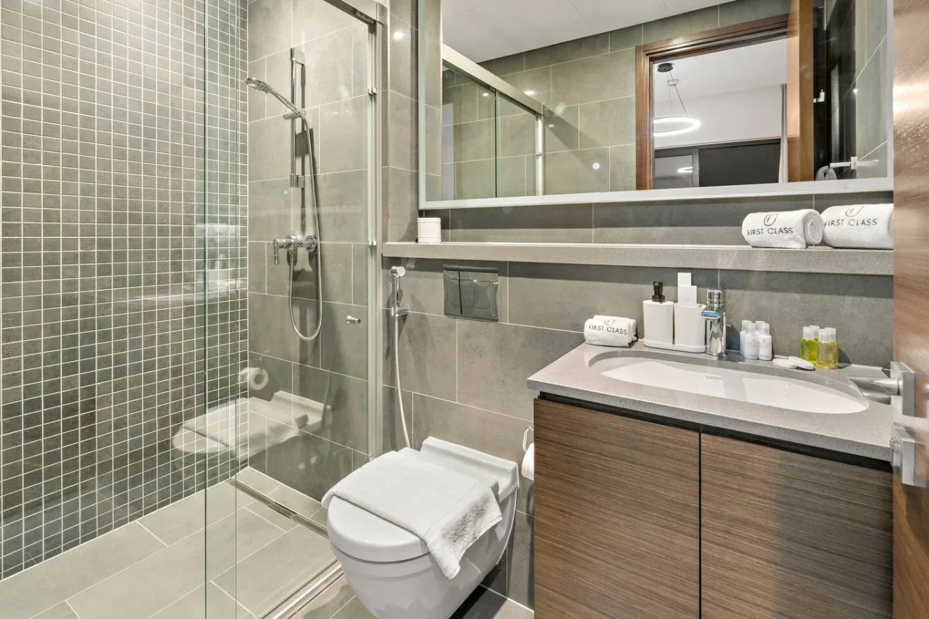 A modern bathroom with a glass shower and a vanity.