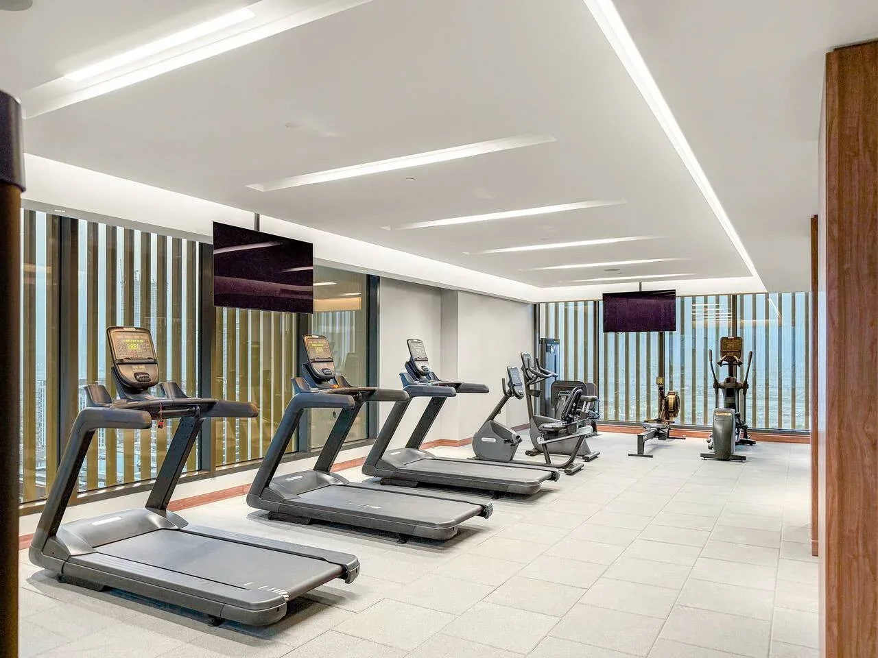 A fitness room with treadmills and other exercise equipment.
