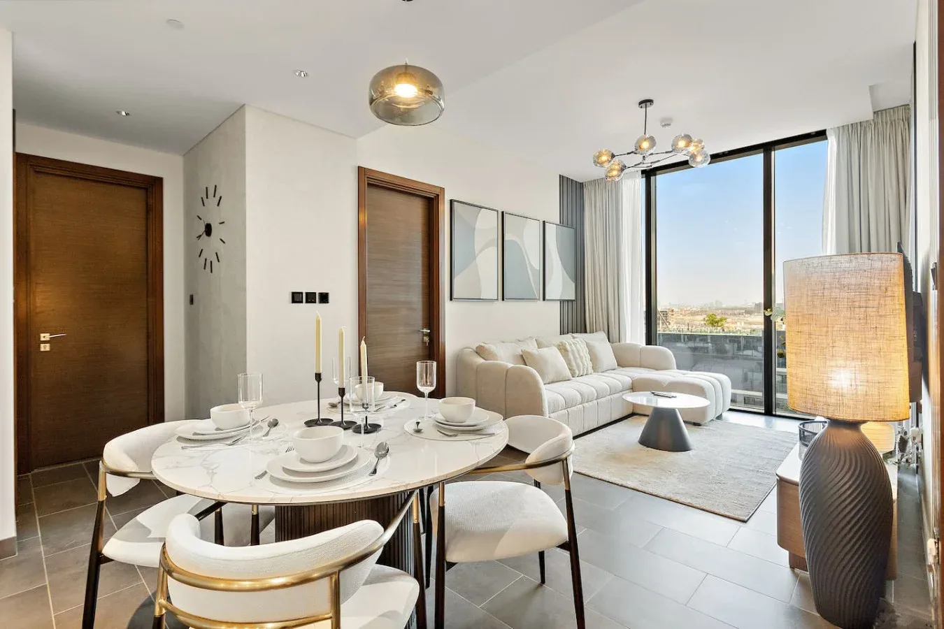 A bright living and dining area with a set dining table beside large windows.