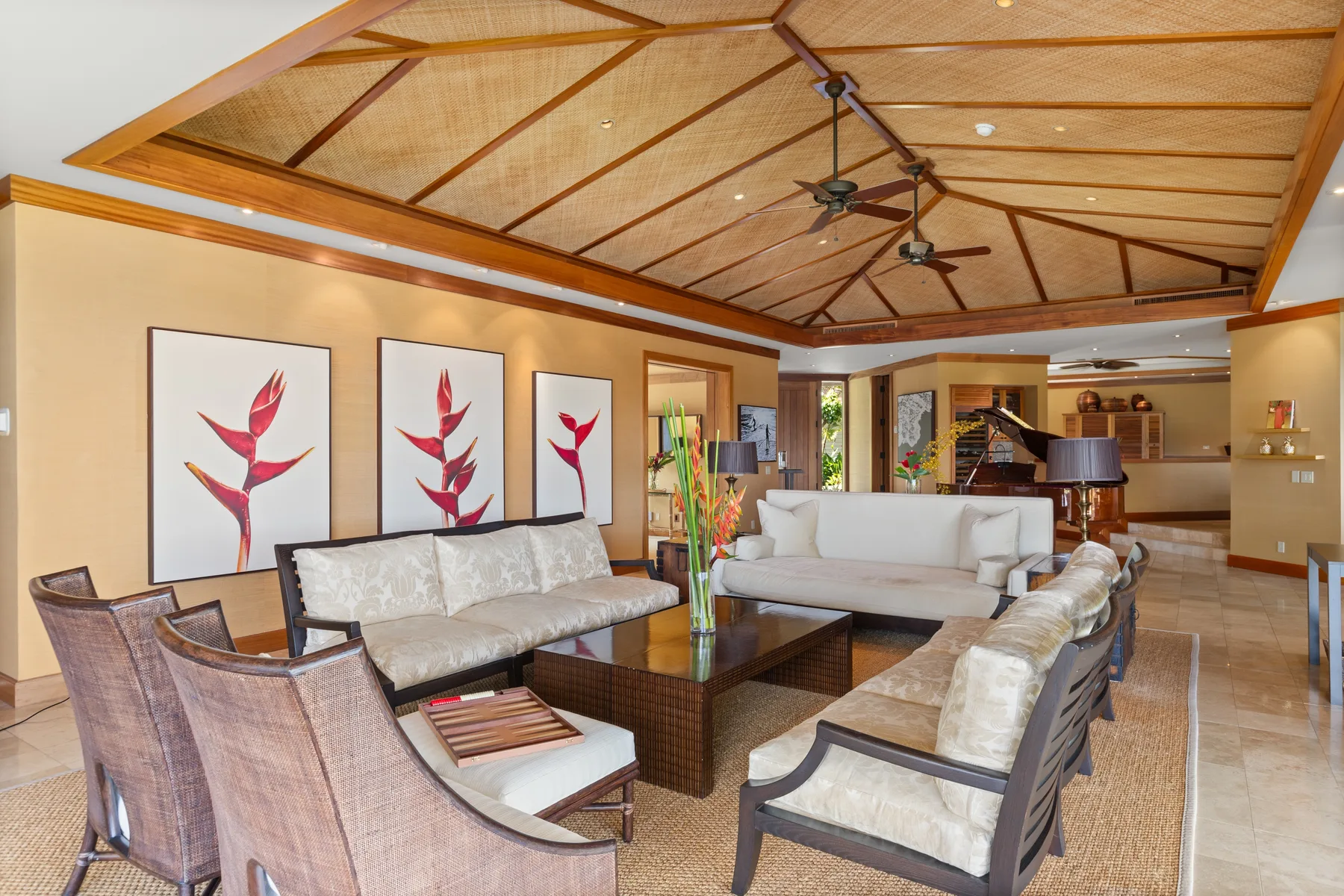 A spacious living room has seating arranged around a low coffee table.