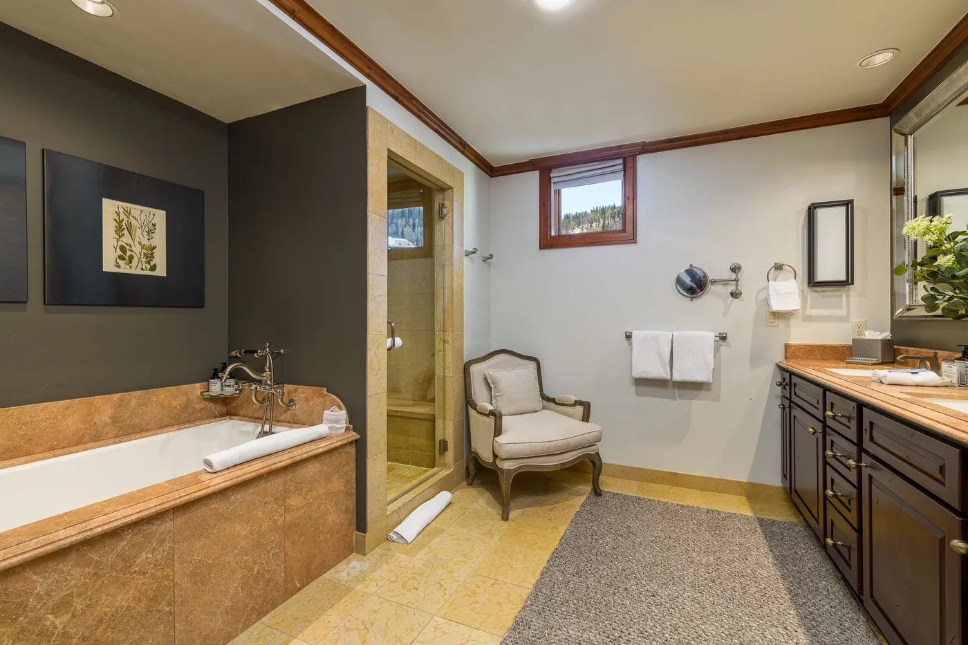 A bathroom with a bathtub, glass shower, and vanity.