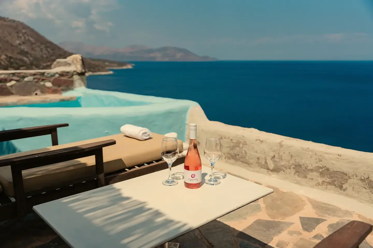 Sun loungers beside the pool at sunset