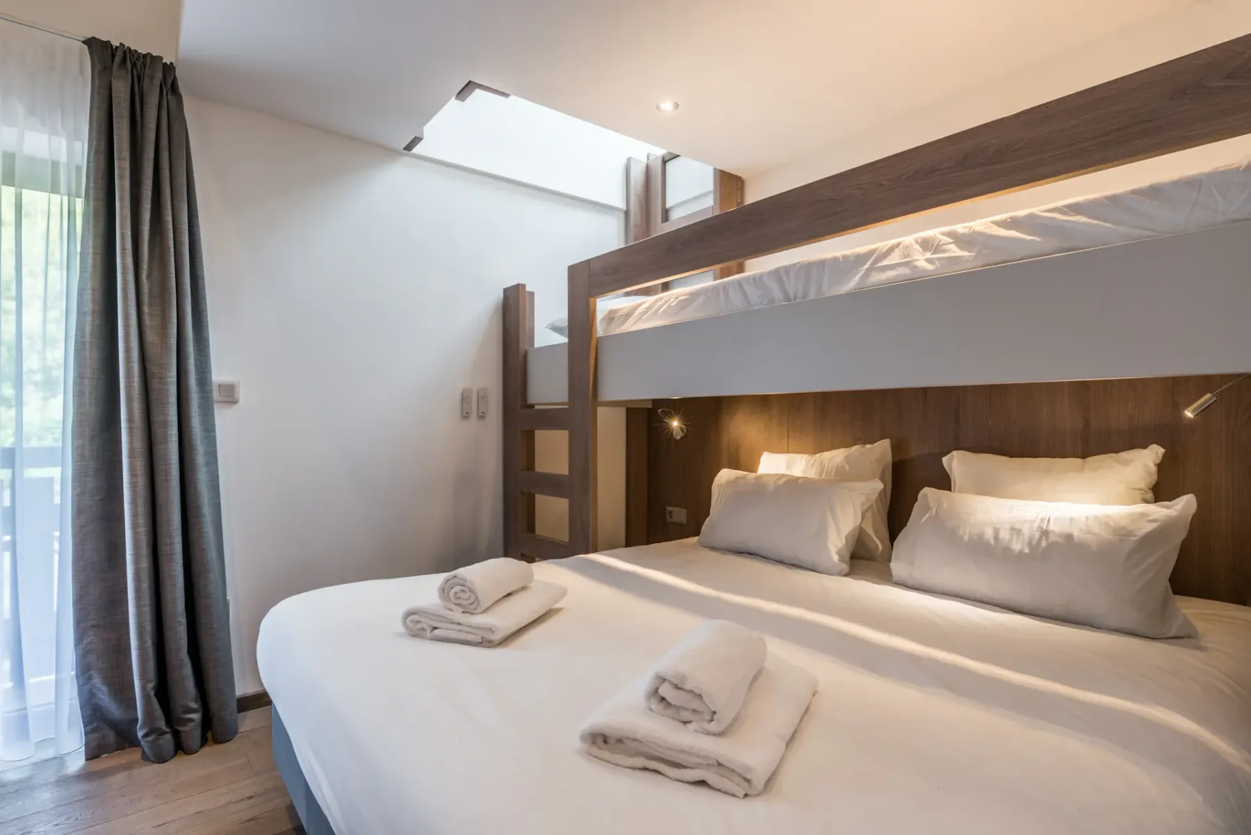 Cosy double bedroom bunk beds ample cupboard space landscape views family apartment Kauri Morzine