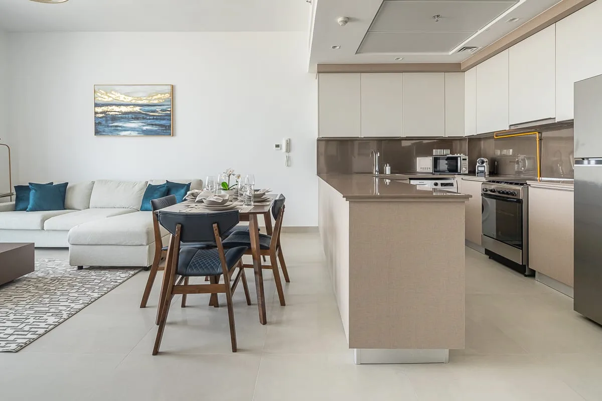 An open-plan living and dining area with an adjoining kitchen and island.