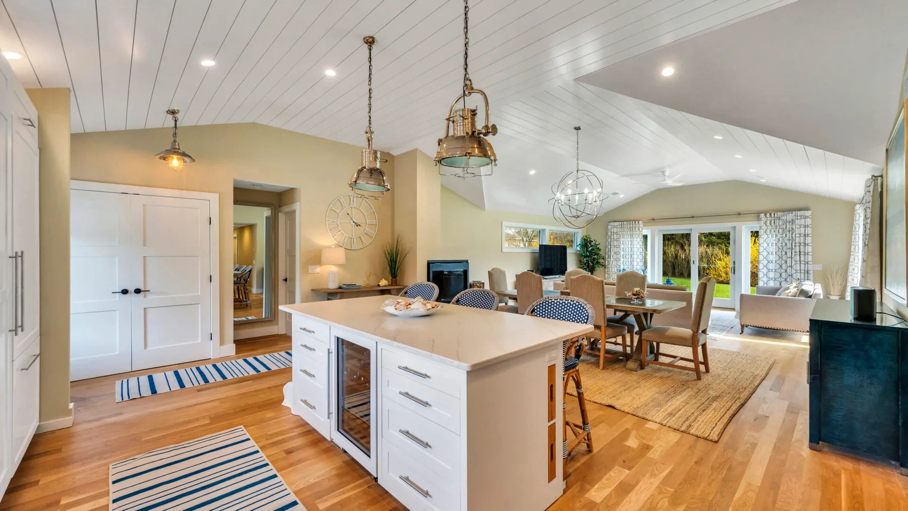 An open kitchen and dining area with a large island and dining table.
