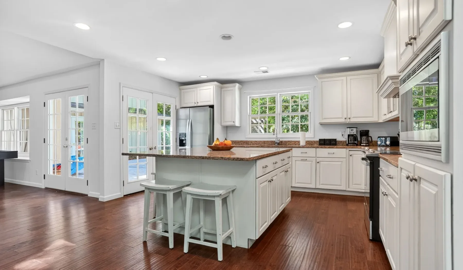 A bright kitchen with white cabinetry and a central island.