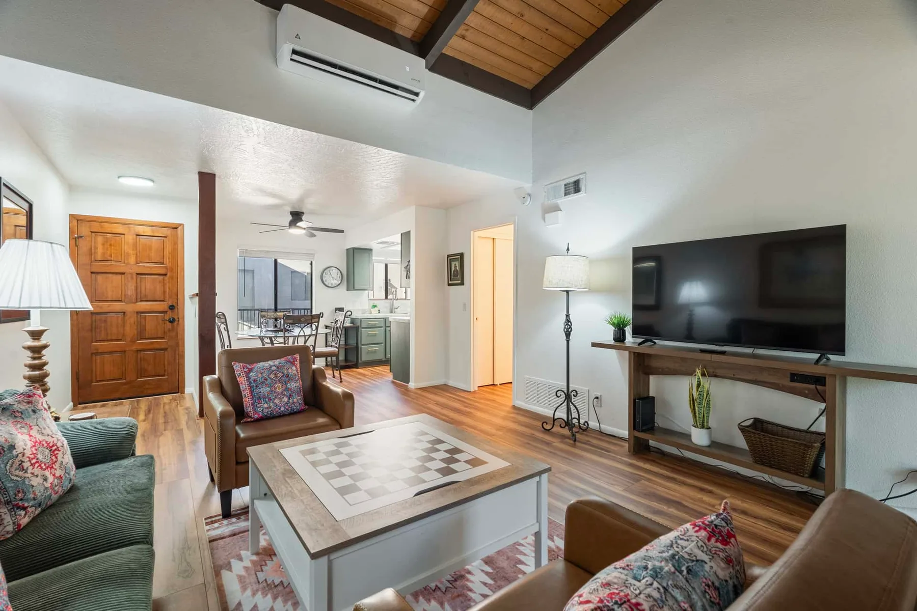 A living room with seating, a coffee table, and a television.