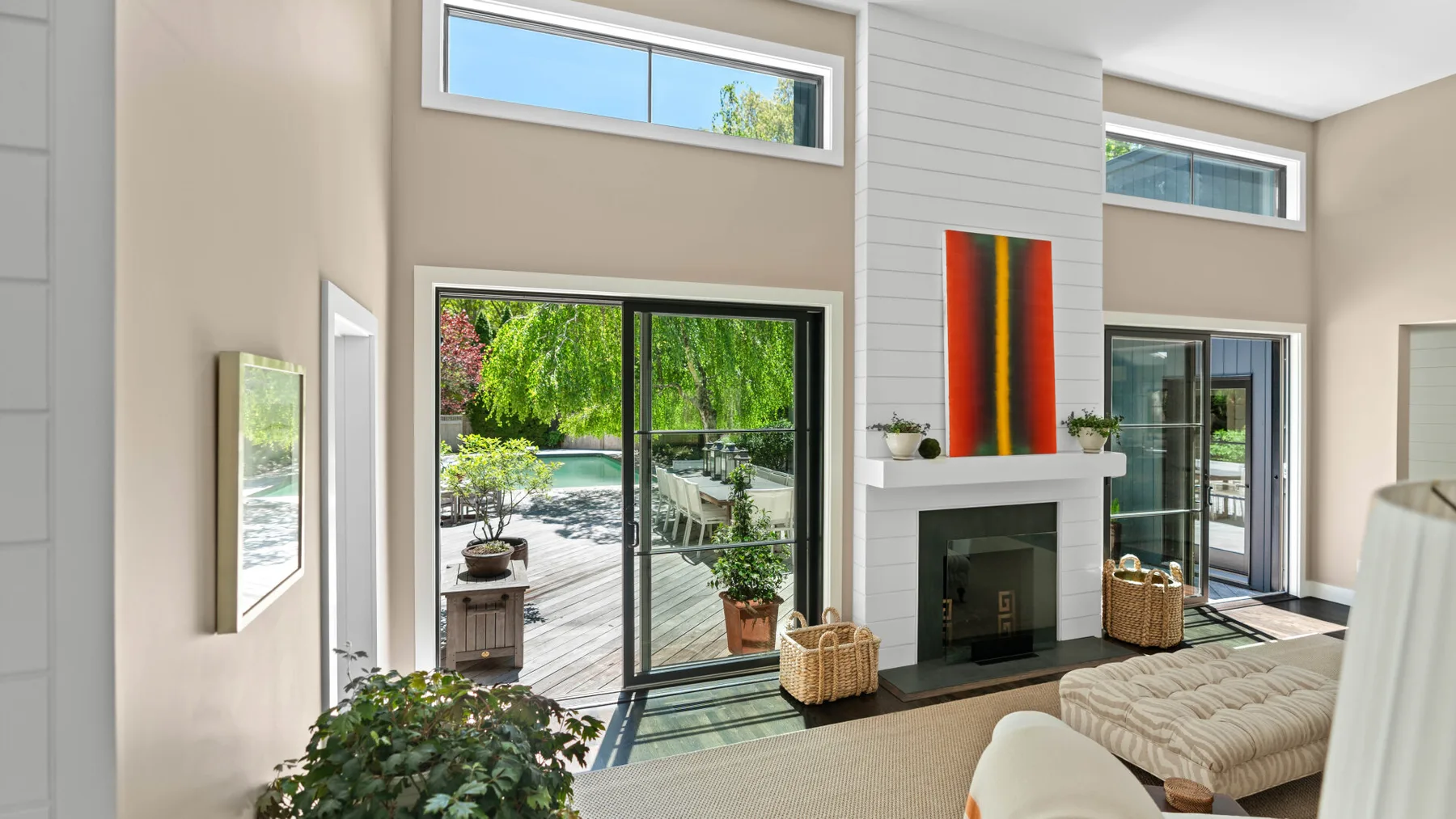 A bright living room with a fireplace and large sliding glass doors.