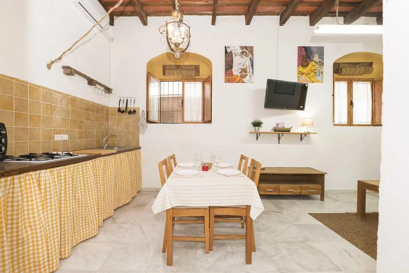 A dining area with a set table beside a kitchen counter.