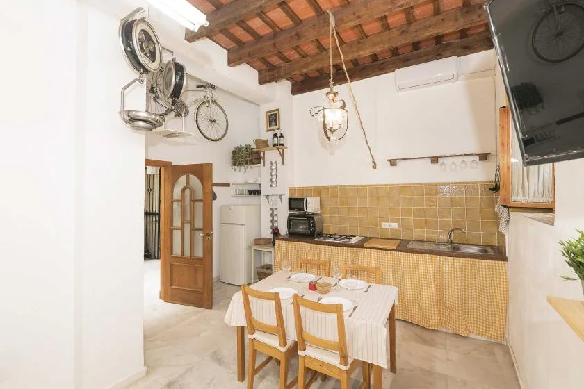 A kitchen and dining area with a table set in front of the counter.