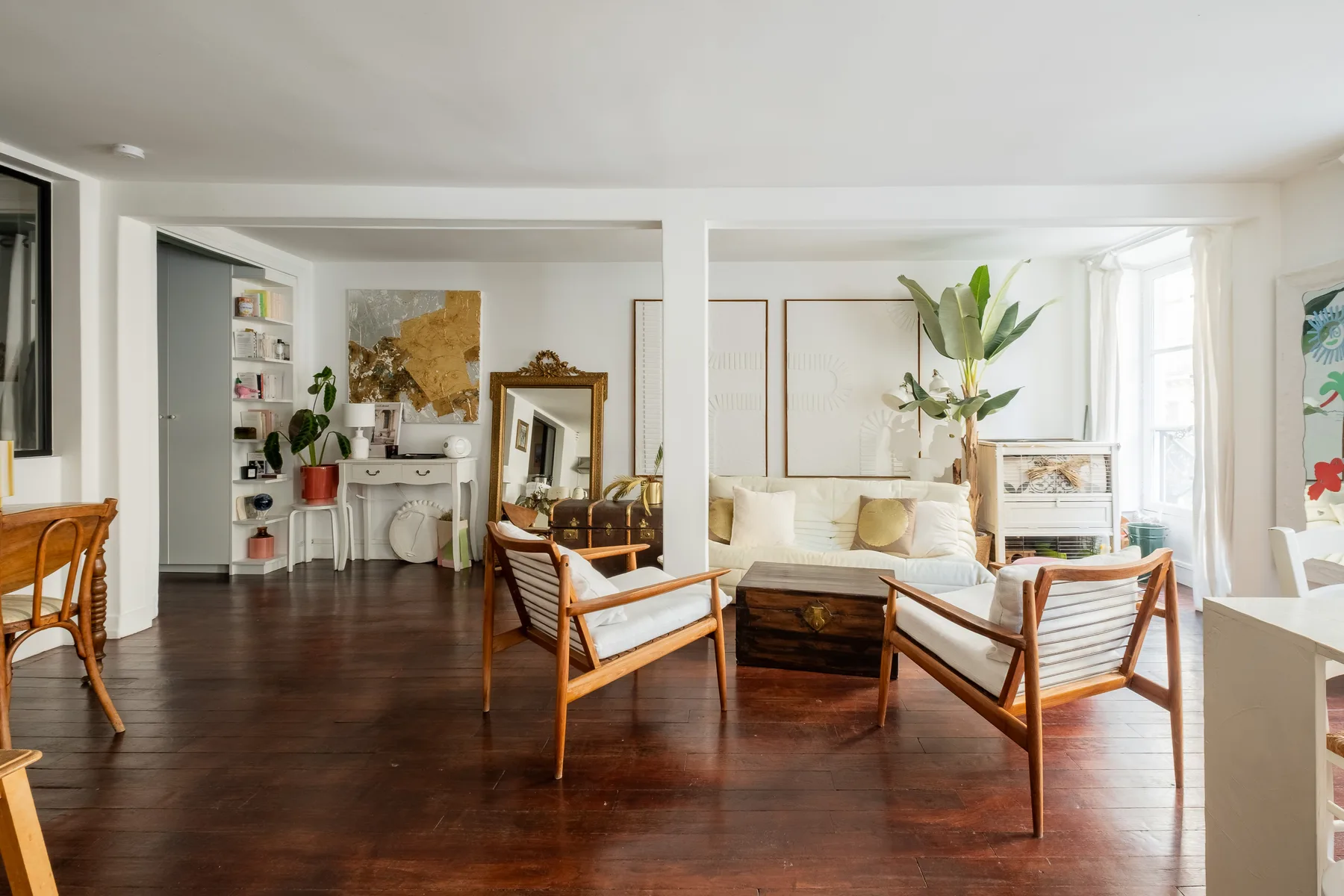 Una sala luminosa con asientos, una mesa de centro y ventanales.