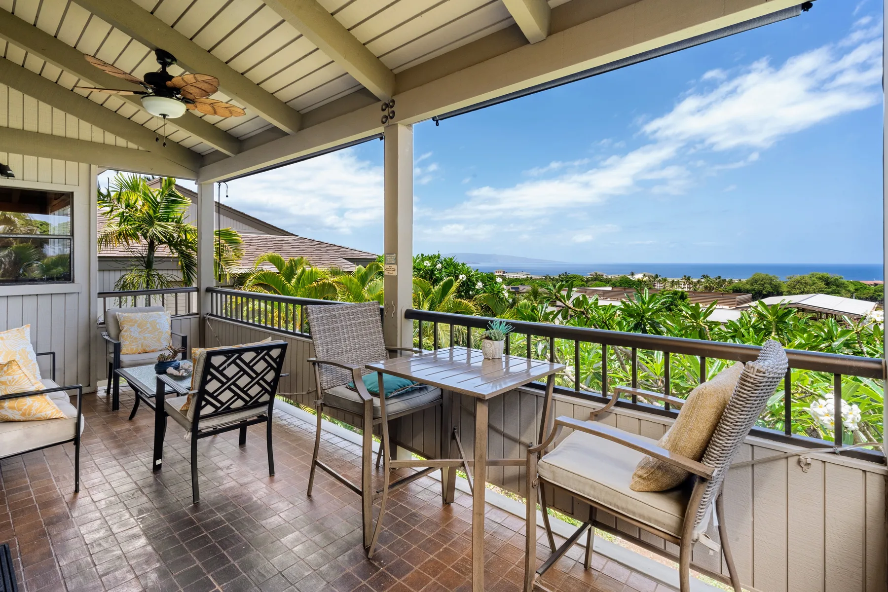 A covered outdoor seating area overlooks the ocean.