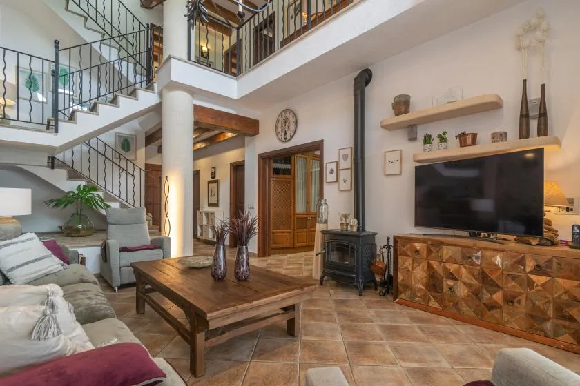 A living room with a wooden coffee table, seating, and a television.