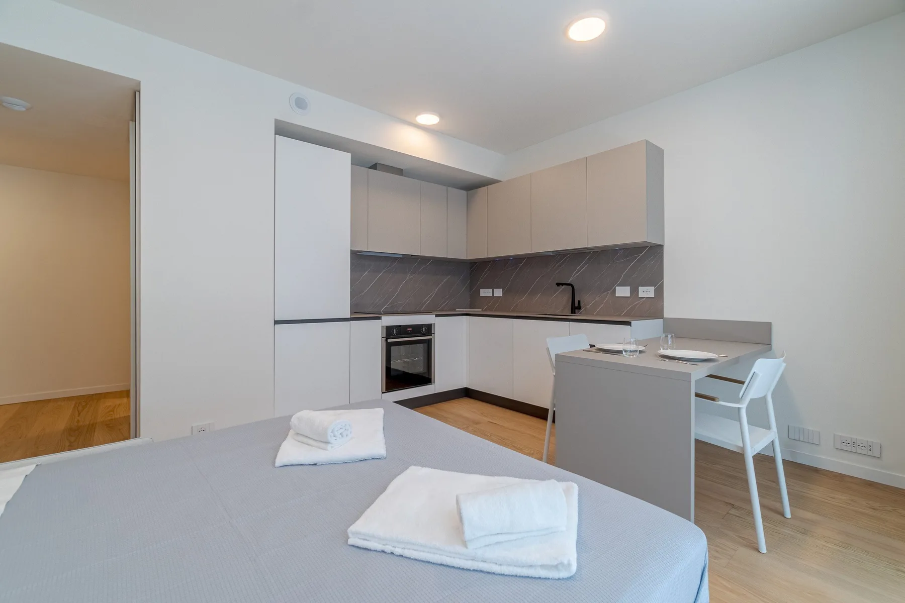 A modern kitchen with a counter and dining seating.