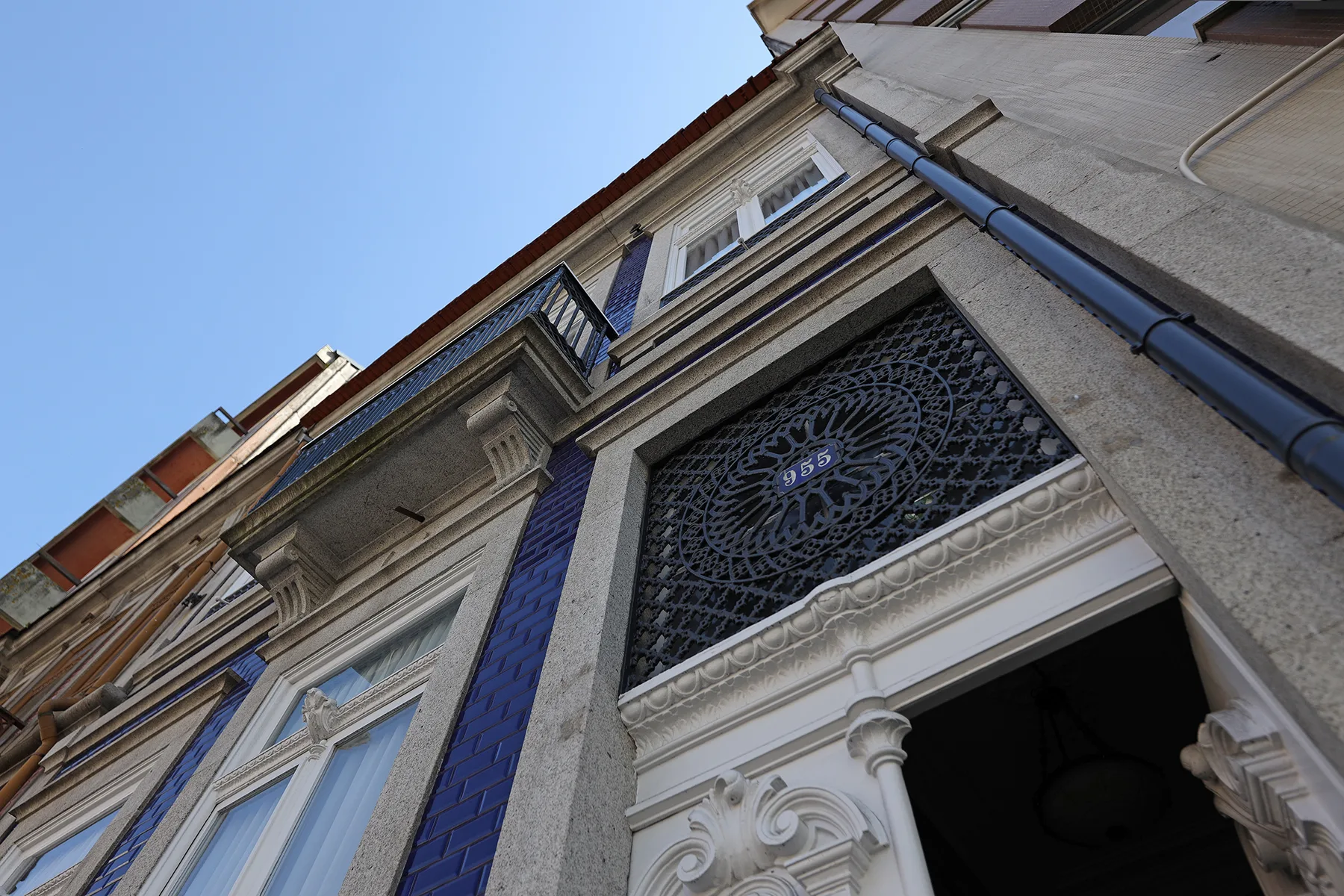 An ornate building entrance with decorative stonework and blue tile accents.