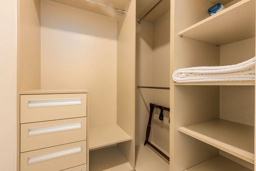 Generous closet space with built-in drawers and shelving keeps your belongings neatly organized, with fresh linens and hangers ready for your stay.