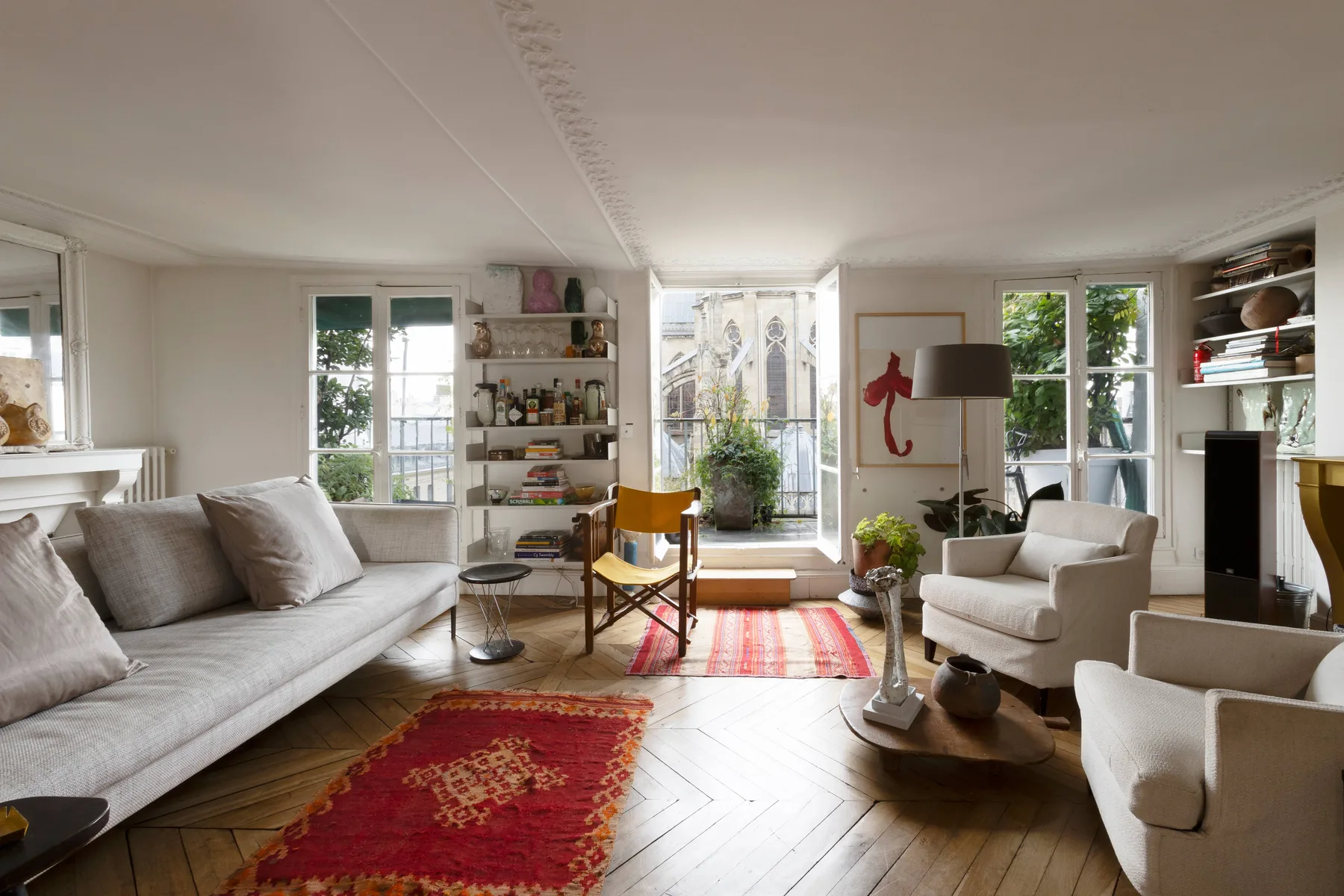 Una sala luminosa con asientos, estanterías y ventanas altas.