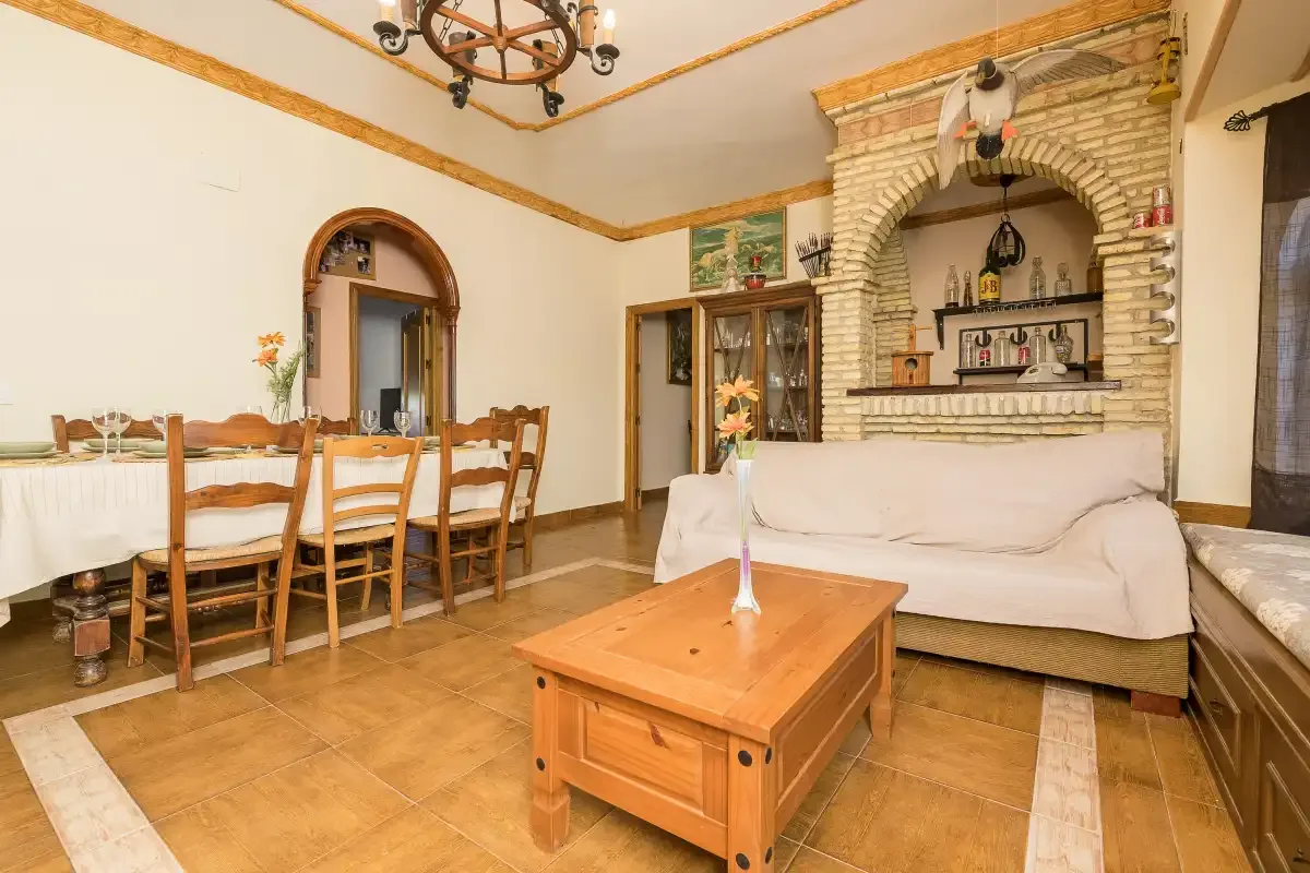 A living and dining room with a wooden coffee table and seating.