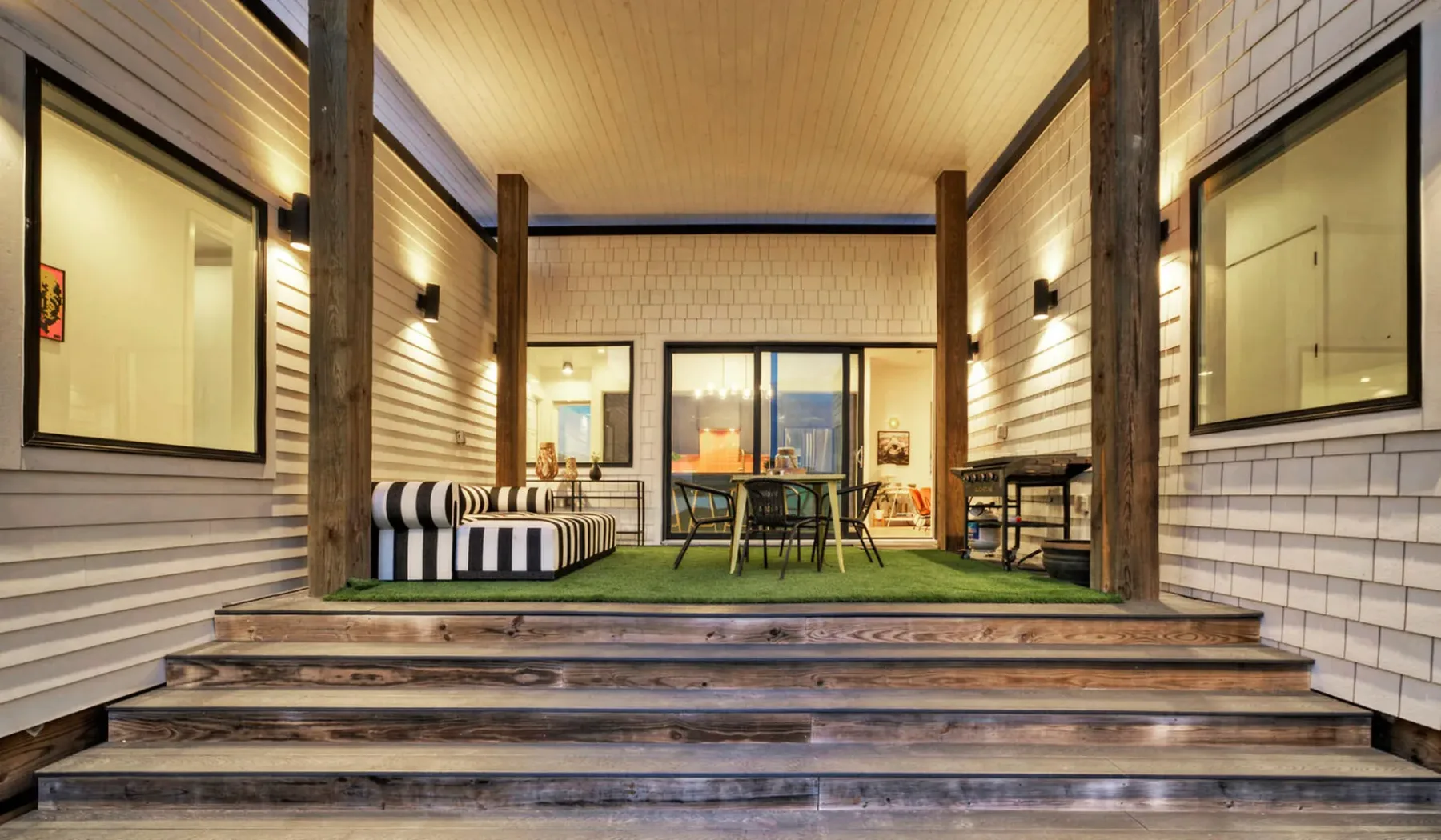 Covered patio with outdoor seating and a dining table.