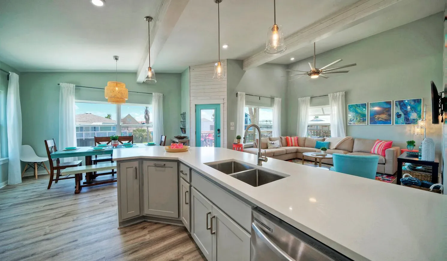 An open-plan kitchen and living area with a dining table and large island.