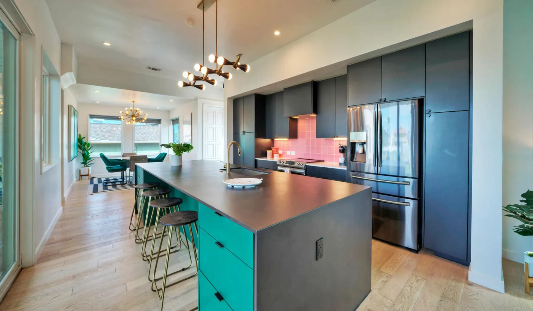 A modern kitchen with a long island and dining area.