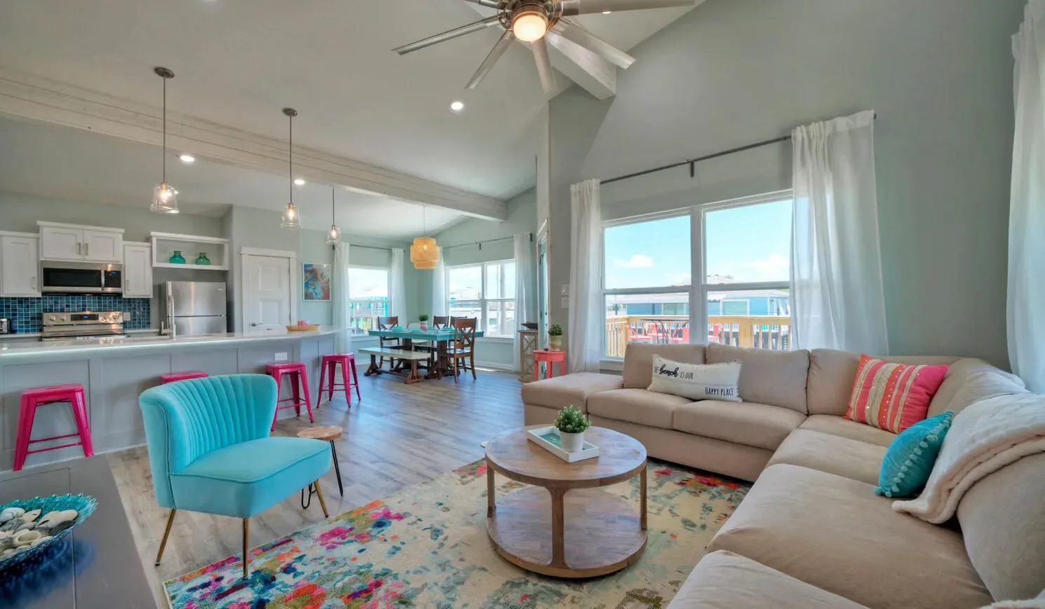 An open-plan living room and kitchen with a sectional sofa and dining area.
