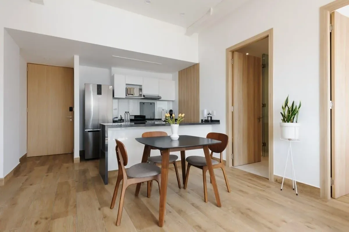 A bright kitchen and dining area with a table beside the counter.